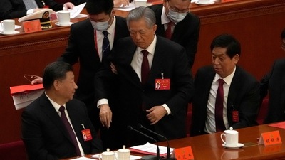 China's Xi Jinping: Former Chinese President Hu Jintao, center, is helped during the closing ceremony. (AP) China's Xi Jinping: Former Chinese President Hu Jintao, center, is helped during the closing ceremony. (AP)