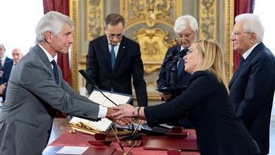 Giorgia Meloni: Italy's new Minister of Sports and Youth Andrea Abodi shakes hands with Italy's new Prime Minister Giorgia Meloni. (via REUTERS)