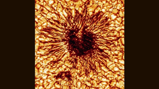A sunspot in extreme close-up. At its heart is a magnetic field so strong it traps light and inhibits convection. The dramatic streaks around the heart are made by blazing plasma trying to find other ways out. (NSF / NSO / AURA)