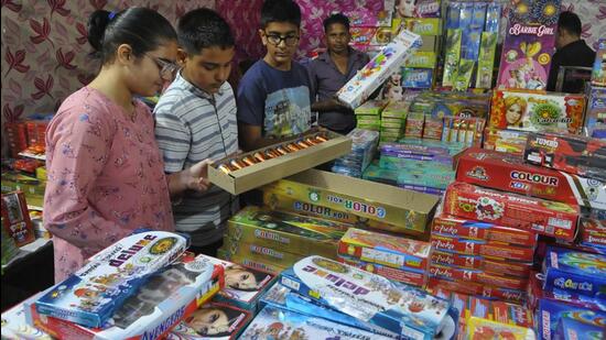 Children buying crackers at a stall in Sector 33, Chandigarh, on Saturday. (Keshav/HT)