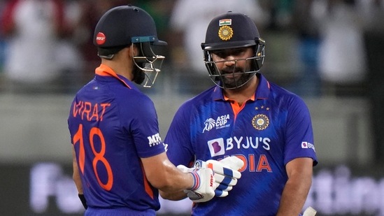 India's captain Rohit Sharma, right, and Virat Kohli celebrate scoring runs during the T20 cricket match (AP)