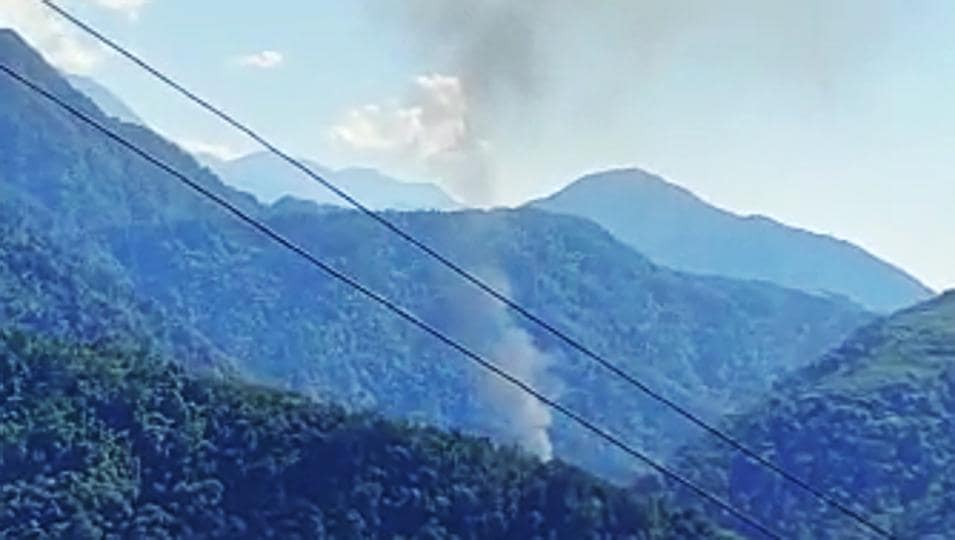Smoke comes out from the site of the helicopter crash in the Upper Siang district of Arunachal Pradesh on Friday. (ANI Photo) Smoke comes out from the site of the helicopter crash in the Upper Siang district of Arunachal Pradesh on Friday. (ANI Photo)