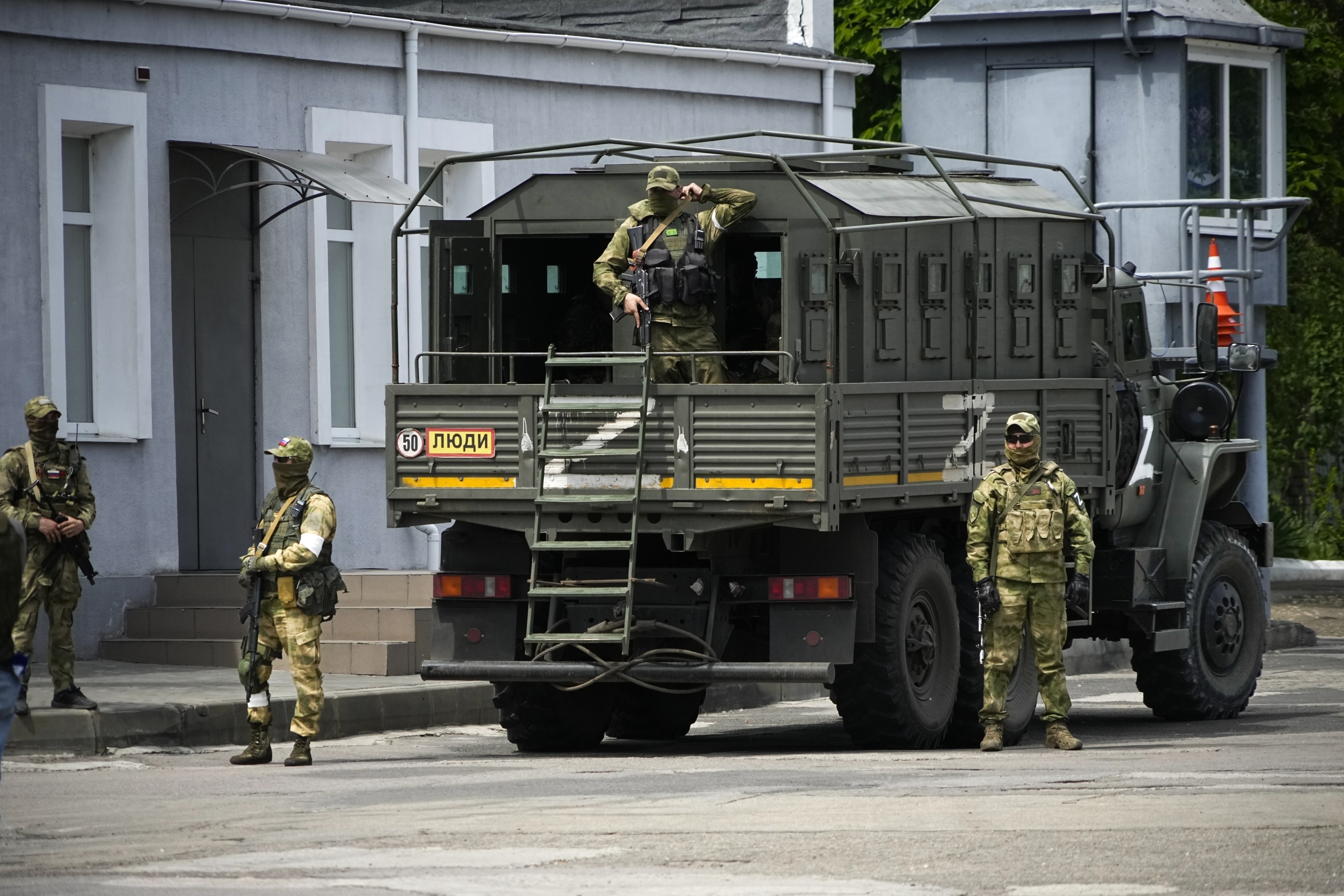 Russian soldiers guard an area as a group of foreign journalists visit in Kherson, south Ukraine. (AP file photo) Russian soldiers guard an area as a group of foreign journalists visit in Kherson, south Ukraine. (AP file photo)