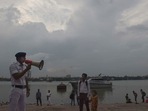 Kolkata: A river traffic police personnel makes an announcement as part of precautionary measures against Cyclone Asani, on the banks of Ganga river, in Kolkata. (PTI Photo) Kolkata: A river traffic police personnel makes an announcement as part of precautionary measures against Cyclone Asani, on the banks of Ganga river, in Kolkata. (PTI Photo)