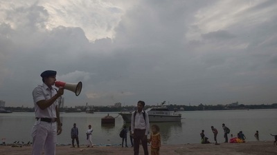 Kolkata: A river traffic police personnel makes an announcement as part of precautionary measures against Cyclone Asani, on the banks of Ganga river, in Kolkata. (PTI Photo)