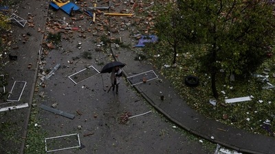 Russia-Ukraine War A local resident walks at a backyard of a residential building in Ukraine. (Reuters)