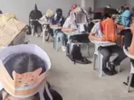 Philippines students wear ‘anti-cheating’ hats during exams(Facebook) Philippines students wear ‘anti-cheating’ hats during exams(Facebook)