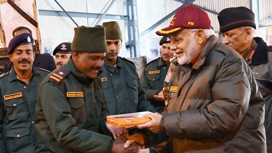 PM Modi exchanges sweets with security personnel in 2018. 