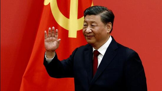 Chinese President Xi Jinping waves after his speech as the new Politburo Standing Committee members meet the media following the 20th National Congress of the Communist Party of China, at the Great Hall of the People in Beijing on October 23 (REUTERS)