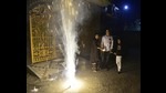 A family watches fireworks on the occasion of Diwali in Amritsar on Monday. (Sameer Sehgal /HT) A family watches fireworks on the occasion of Diwali in Amritsar on Monday. (Sameer Sehgal /HT)