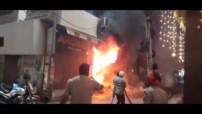 Firefighters douse the fire that broke out at a garment store in Moga on Diwali. (HT Photo)