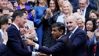 Rishi Sunak, centre, gestures as conservative MPs greet him. (AP) Rishi Sunak, centre, gestures as conservative MPs greet him. (AP)