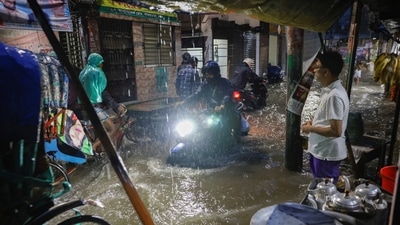 People ride rickshaws and motorcycle on a flooded street, amid continuous rain before the Cyclone Sitrang hits the country in Dhaka, Bangladesh, October 24, 2022. (Reuters)