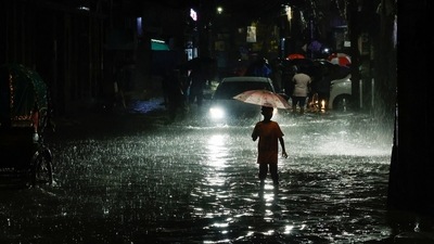 A boy wades through water as streets are flooded due to continuous rain, before the Cyclone Sitrang hits the country in Dhaka, Bangladesh, October 24, 2022. (Reuters)