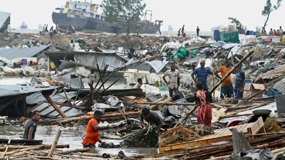 Residents search for their belongings amid the debris of their collapsed huts after the cyclone Sitrang hit Bangladesh's Chittagong on Tuesday. (AFP) (AFP) Residents search for their belongings amid the debris of their collapsed huts after the cyclone Sitrang hit Bangladesh's Chittagong on Tuesday. (AFP) (AFP)