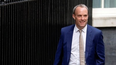 Dominic Raab walks outside Number 10 Downing Street, in London. (REUTERS)