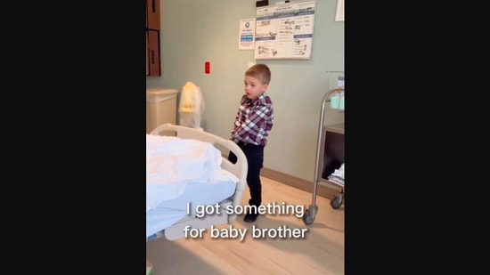 The image, taken from the Instagram video, shows the boy going to give the gift to his newborn baby brother. (Instagram/@lauramhess)