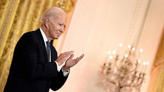 US President Joe Biden claps as he hosts a reception to celebrate Diwali.(AFP)