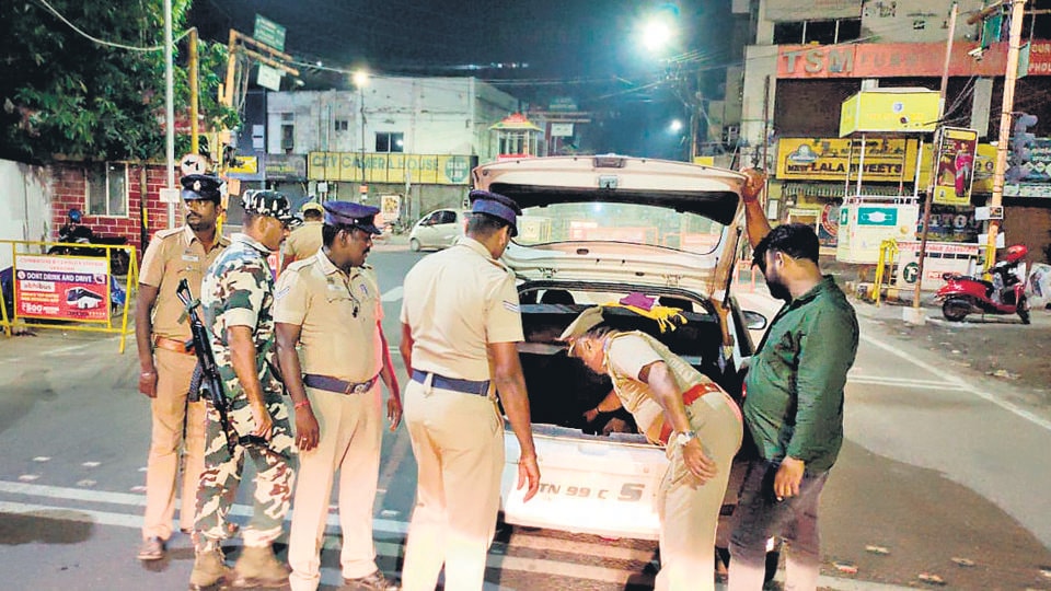 Police check vehicles following a cylinder explosion in a Maruti 800 in Coimbatore on Monday. (ANI) Police check vehicles following a cylinder explosion in a Maruti 800 in Coimbatore on Monday. (ANI)