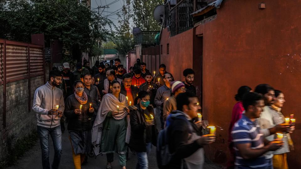 Local residents during a candlelight protest against the killing of a Kashmiri Pandit in Srinagar. (AP) Local residents during a candlelight protest against the killing of a Kashmiri Pandit in Srinagar. (AP)