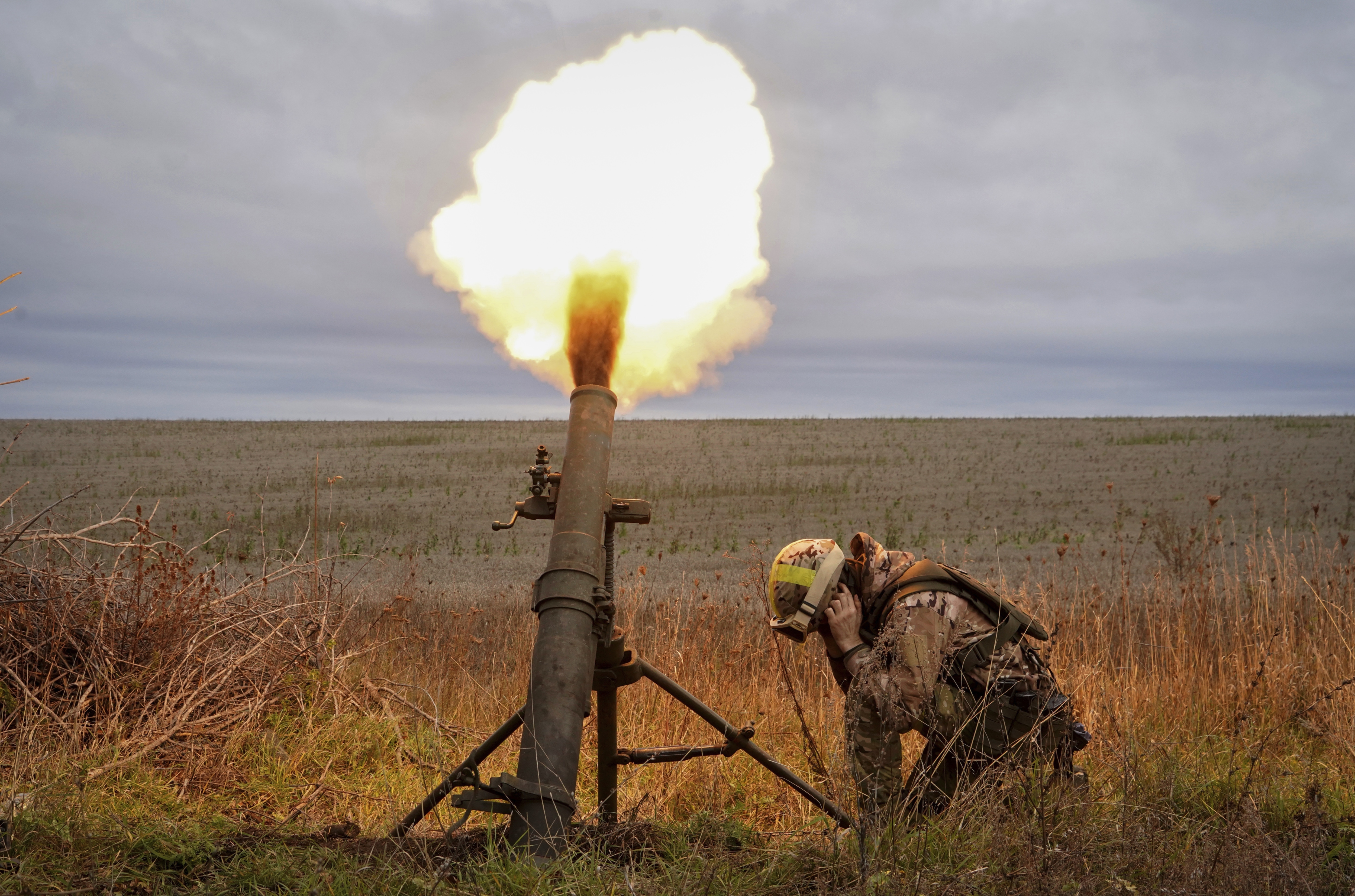 Ukrainian National guard soldiers fire at Russian positions with a mortar near Kharkiv. (AP) Ukrainian National guard soldiers fire at Russian positions with a mortar near Kharkiv. (AP)