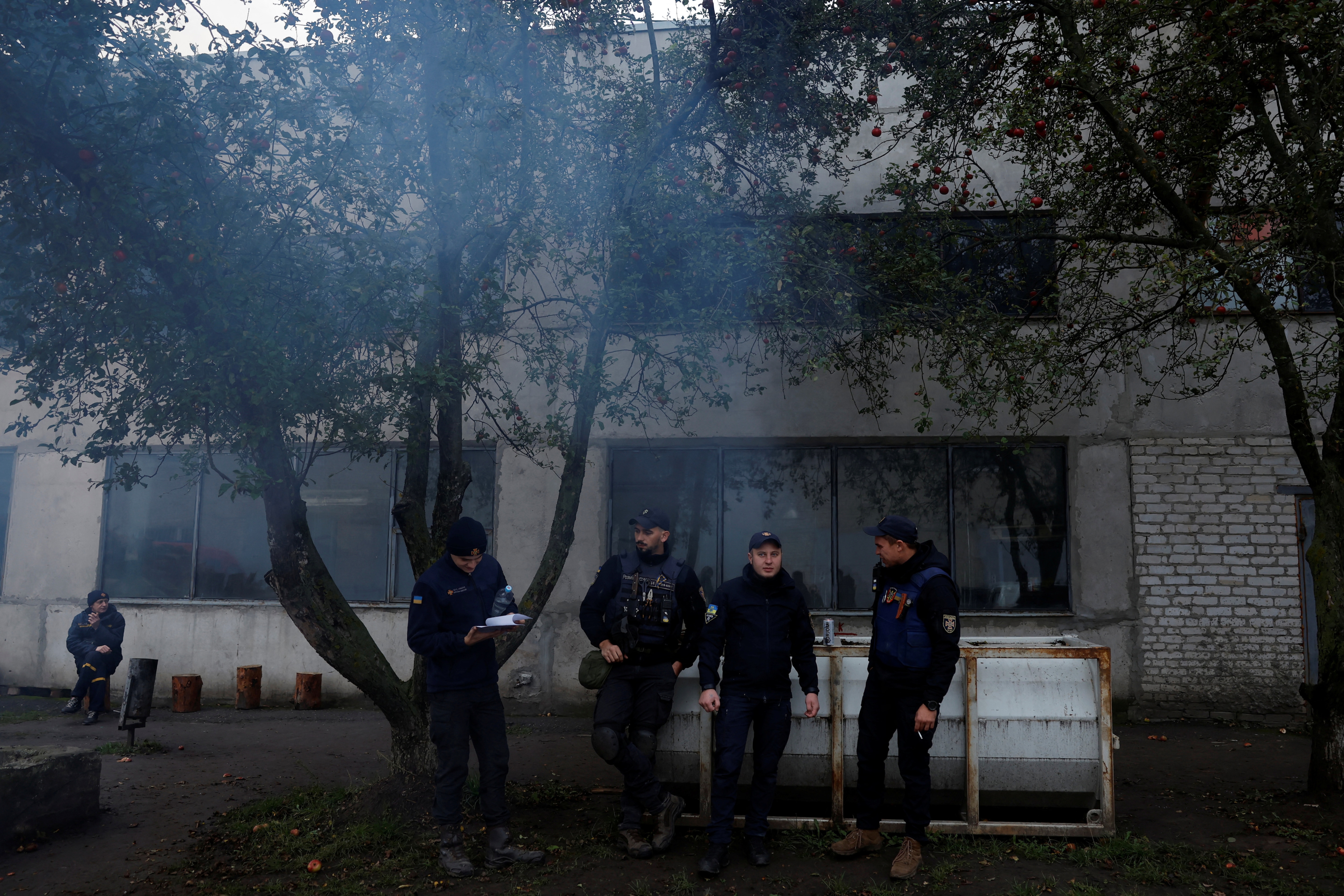 Firefighters' de-mining squad from the Ukrainian emergency services prepare to scan for land mines and other unexploded ordinates to clear an area for electricians to access electricity power lines damaged by Russian strikes in order to repair them safely. (REUTERS)
