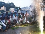 Workers of the Janata Dal (Secular) burst crackers on pothole-ridden roads of Bengaluru on Tuesday.