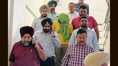 The juvenile (face covered) in Mohali police custody on Wednesday. The juvenile (face covered) in Mohali police custody on Wednesday.