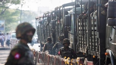 Myanmar: A soldier stand next to military vehicles. (Reuters) Myanmar: A soldier stand next to military vehicles. (Reuters)