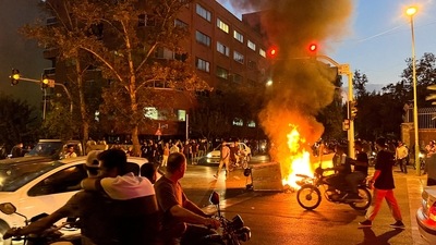 A police motorcycle burns during a protest over the death of Mahsa Amini, a woman who died after being arrested by the Islamic republic's "morality police", in Tehran, Iran September 19, 2022. (REUTERS)