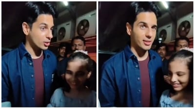 Sidharth Malhotra posing with a young fan named Kiara at Thank God screening. Sidharth Malhotra posing with a young fan named Kiara at Thank God screening.