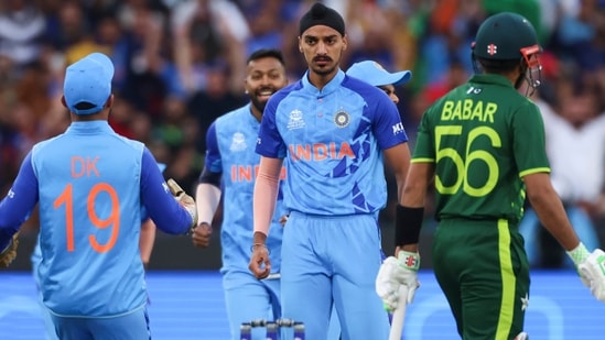 India's Arshdeep Singh, centre, reacts after dismissing Pakistan's Babar Azam, right, during the T20 World Cup cricket match between India and Pakistan in Melbourne, Australia, Sunday, Oct. 23, 2022. (AP)