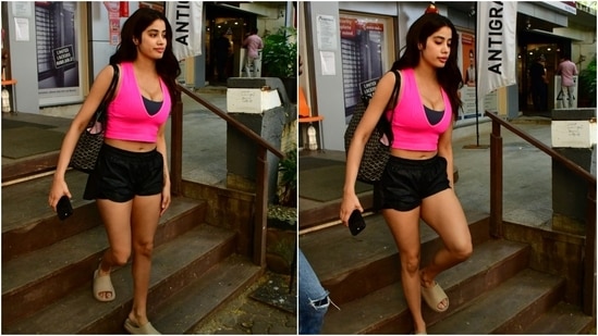 Flaunting her toned abs, Janhvi wore a sleeveless bright pink crop top featuring a plunging V neckline and a cropped hem length. She wore it over a black sports bra. (HT Photo/Varinder Chawla)
