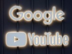 The logos of Google and YouTube are seen in Davos, Switzerland.