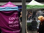 New Covid Wave In Europe: People walk by a mobile coronavirus disease (COVID-19)  testing center.