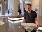 Elon Musk enters the Twitter headquarters carrying a sink through the lobby area, in San Francisco, USA on Thursday. (PTI) Elon Musk enters the Twitter headquarters carrying a sink through the lobby area, in San Francisco, USA on Thursday. (PTI)