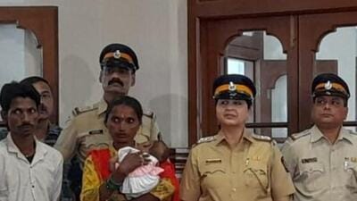 Parents holding the baby girl along with senior police officials. (HT Photo)