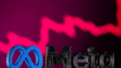 Facebook's new rebrand logo Meta is seen in front of displayed stock graph. (REUTERS)