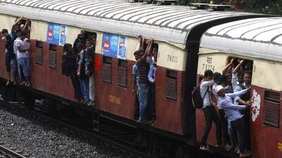 Passengers travel on the footboards of a suburban local train in Mumbai. (Kunal Patil/ HT File Photo)