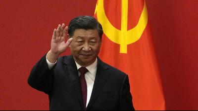 Chinese President Xi Jinping waves at an event to introduce new members of the Politburo Standing Committee at the Great Hall of the People in Beijing on Sunday. (AP) Chinese President Xi Jinping waves at an event to introduce new members of the Politburo Standing Committee at the Great Hall of the People in Beijing on Sunday. (AP)