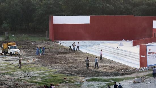 Workers clean-up a ghat along the Yamuna in Delhi. (ANI)