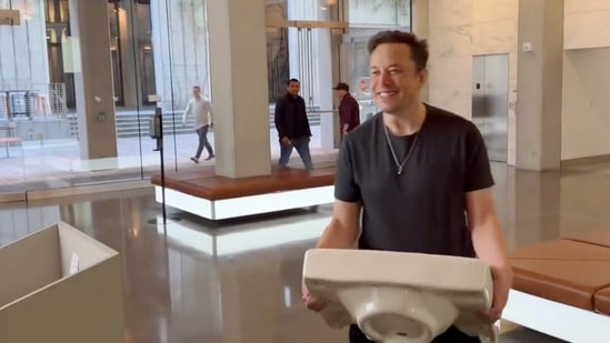 Elon Musk enters the Twitter headquarters carrying a sink through the lobby area, in San Francisco, USA on Thursday. (PTI)