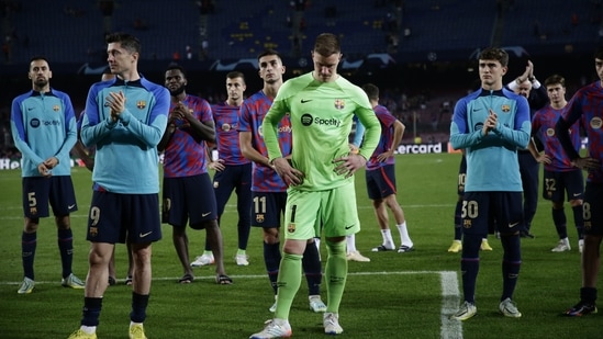 Barcelona players stand in dejection as they applaud fans at the end of the Champions League Group C soccer match between Barcelona and Bayern Munich at the Camp Nou stadium(AP)