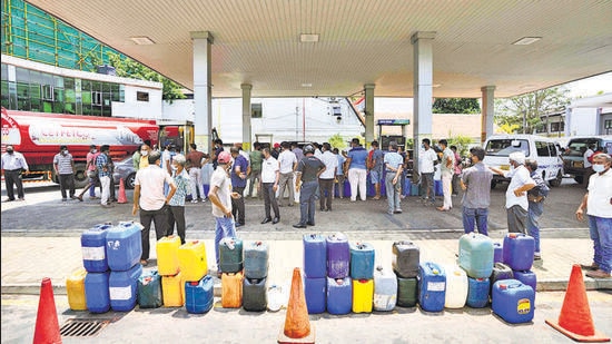 Sri Lankans gather at a fuel pump with empty containers to buy diesel in Colombo, Sri Lanka, Thursday, March 24, 2022. Sri Lanka’s foreign reserves are dwindling at a time when it faces huge debt obligations. The country’s struggle to pay for imports has caused shortages of medicine, fuel, milk powder, cooking gas and other essentials, with people waiting in long queues to get fuel. (AP Photo/Eranga Jayawardena) (AP)