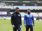 Ireland's captain Andrew Balbirnie, left, and Afghanistan's captain, Mohammad Nabi walk from the field after their match was abandoned due to rain at the T20 World Cup cricket in Melbourne