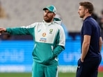 Australia's Aaron Finch (L) chats to England's Jos Buttler