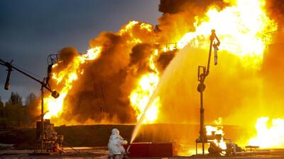 A firefighter works at the site of burning tanks after shelling of an oil depot by Ukrainian forces in Shakhtarsk, Donetsk People’s Republic, eastern Ukraine, on Thursday. (AP) A firefighter works at the site of burning tanks after shelling of an oil depot by Ukrainian forces in Shakhtarsk, Donetsk People’s Republic, eastern Ukraine, on Thursday. (AP)