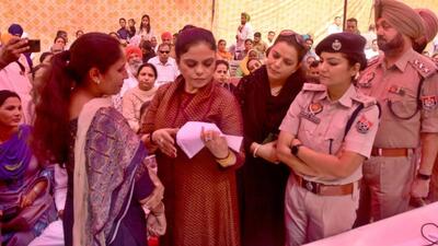 Punjab Women Commission chairperson Manisha Gulati with senior police officials interacting with residents during the Lok Adalat at Police Lines in Ludhiana. (Harvinder Singh/H)