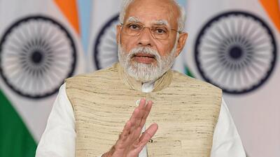 Prime Minister Narendra Modi addresses the Bhoomi Poojan ceremony of the expansion of ArcelorMittal Nippon Steel (AM/NS) integrated facility at Hazira, in Gujarat, via video conferencing in New Delhi, Friday. (PTI/PIB Photo) Prime Minister Narendra Modi addresses the Bhoomi Poojan ceremony of the expansion of ArcelorMittal Nippon Steel (AM/NS) integrated facility at Hazira, in Gujarat, via video conferencing in New Delhi, Friday. (PTI/PIB Photo)