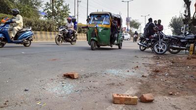 On Tuesday, a seven-second video of the incident, captured by passengers in a passing car, went viral. The video shows the man lying on the road and one of the suspects repeatedly hitting him in the head with bricks. (PTI) On Tuesday, a seven-second video of the incident, captured by passengers in a passing car, went viral. The video shows the man lying on the road and one of the suspects repeatedly hitting him in the head with bricks. (PTI)